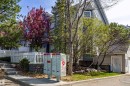 Picket fence frontage with mature landscaping, including a vibrant flowering tree - 41 8304 11 Avenue, Edmonton, AB  - Outdoor 