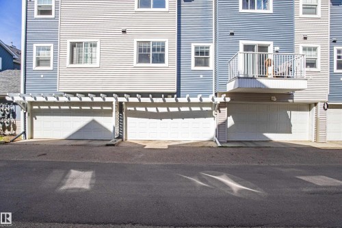 Multi-level building with horizontal siding in varying blue and grey tones - 41 8304 11 Avenue, Edmonton, AB - Outdoor