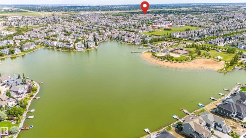 Aerial overview of a large lake surrounded by a residential neighborhood - 41 8304 11 Avenue, Edmonton, AB - Outdoor With Body Of Water With View