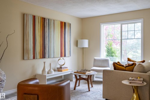 Warm-toned walls feature a large picture window with white trim - 41 8304 11 Avenue, Edmonton, AB - Indoor