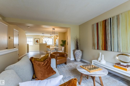 Living area featuring light wood-finish flooring and a neutral color palette - 41 8304 11 Avenue, Edmonton, AB - Indoor Photo Showing Living Room