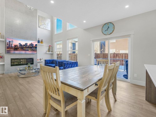 8641 Mayday Wynd, Edmonton, AB - Indoor Photo Showing Dining Room With Fireplace
