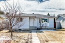 Single-story residence featuring light-colored siding, a prominent front door with house numbers, and a large bay window - 8615 42A Avenue, Edmonton, AB  - Outdoor 