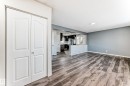Living space featuring wood-finish flooring, light gray wall paint, and a ceiling-mounted light fixture - 8615 42A Avenue, Edmonton, AB  - Indoor Photo Showing Other Room 