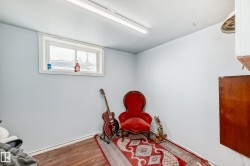 Recessed window with white trim, light blue painted walls, and wood-finish flooring - 