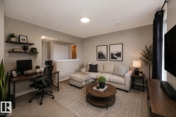 Open-concept living space featuring neutral wall tones and recessed lighting - 