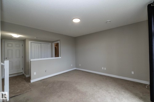 Neutral tone wall paint with white trim, recessed lighting, and carpeted flooring - 117 Callaghan Drive Sw, Edmonton, AB - Indoor Photo Showing Other Room