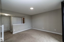 Neutral tone wall paint with white trim, recessed lighting, and carpeted flooring - 