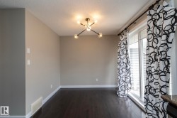 Dark wood-finish flooring complements light neutral wall tones - 