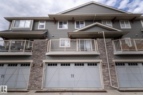 Multi-level exterior featuring horizontal siding and stone veneer accents - 117 Callaghan Drive Sw, Edmonton, AB - Outdoor