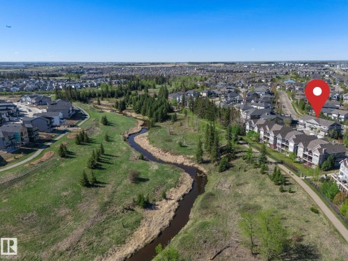 Aerial depiction of a residential area featuring a winding natural watercourse - 117 Callaghan Drive Sw, Edmonton, AB - Outdoor With View