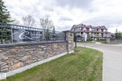 Stone veneer and wrought iron fencing define the property entrance - 