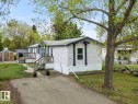 Single-story residence featuring light-colored siding and dark trim accents - 49 Rim Road Nw, Edmonton, AB  - Outdoor 
