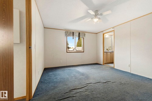 Spacious room featuring blue carpeting and white paneled walls - 49 Rim Road Nw, Edmonton, AB - Indoor Photo Showing Other Room
