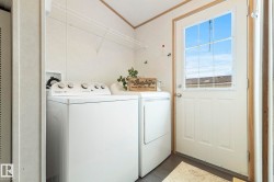 Dedicated laundry area featuring wire shelving, durable flooring, and direct exterior access - 
