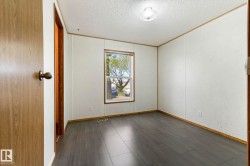 Room featuring wood-finish flooring and a rectangular window - 