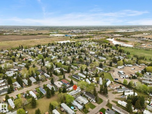 Aerial perspective showcasing a residential community with numerous detached properties and established trees - 49 Rim Road Nw, Edmonton, AB - Outdoor With View