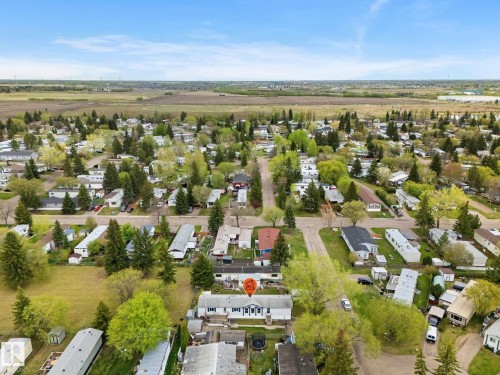 Aerial view of a residential community with numerous detached homes, mature trees, and paved streets - 49 Rim Road Nw, Edmonton, AB - Outdoor With View