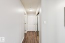 Entryway featuring wood-style flooring, a white paneled door, and a mirrored closet door - 202 17511 98A Avenue, Edmonton, AB  - Indoor Photo Showing Other Room 