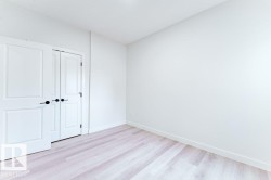 Light-toned wood-finish flooring complements the neutral wall color - 