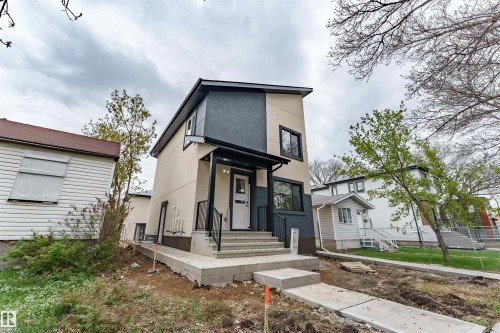 Contemporary two-story residence featuring a striking two-tone facade in light beige and dark gray - 6920/6922 106 Street, Edmonton, AB - Outdoor With Facade