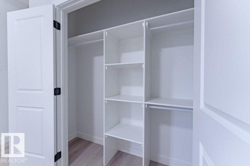 Custom closet system featuring multiple shelves and hanging rods - 6920/6922 106 Street, Edmonton, AB - Indoor With Storage