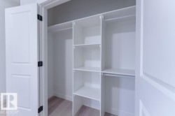 Custom closet system featuring multiple shelves and hanging rods - 
