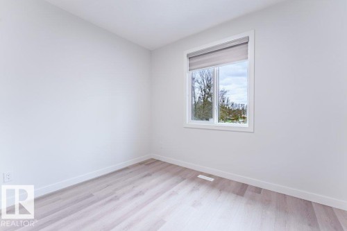 Room featuring light wood-finish flooring, white walls, and white baseboards - 6920/6922 106 Street, Edmonton, AB - Indoor Photo Showing Other Room