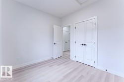 White interior walls with light wood-finish flooring - 