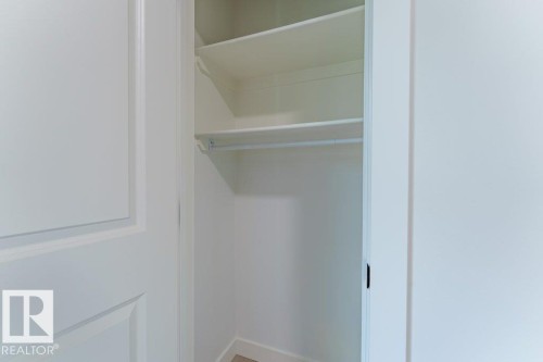 White interior closet featuring multiple shelves and a hanging rod - 6920/6922 106 Street, Edmonton, AB - Indoor With Storage