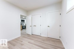 Interior space featuring light wood-finish flooring, white walls, and a white trim - 