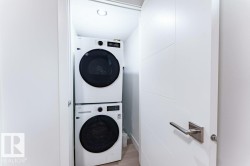 Dedicated laundry closet with stacked front-load washer and dryer units - 