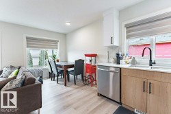 Open-concept kitchen and dining area featuring light wood-finish flooring - 