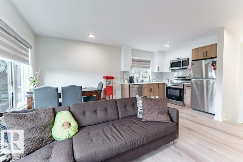 Open concept living area featuring light wood-finish flooring - 6920/6922 106 Street, Edmonton, AB - Indoor Photo Showing Other Room