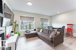 Open concept living area with light wood-finish flooring - 
