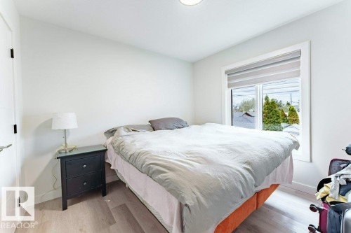 Bright interior space featuring light wood-finish flooring - 6920/6922 106 Street, Edmonton, AB - Indoor Photo Showing Bedroom