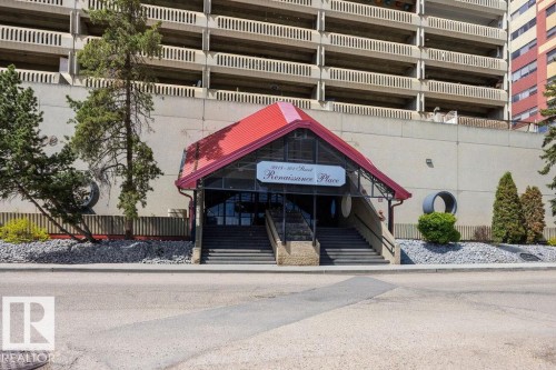 Renaissance Place entry featuring a red gabled roof, two sets of concrete steps with metal railings, and a glass-enclosed vestibule - 1208 9918 101 Street, Edmonton, AB - Outdoor With Balcony