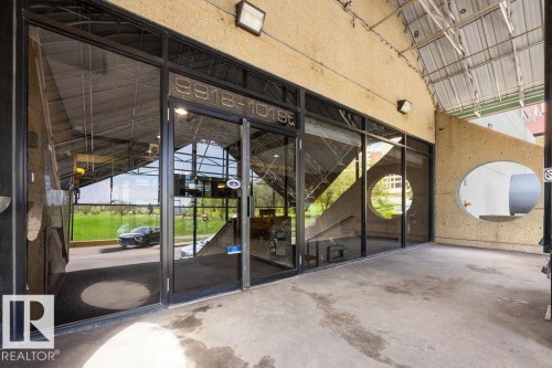 Commercial storefront featuring expansive glass windows and doors - 1208 9918 101 Street, Edmonton, AB - 