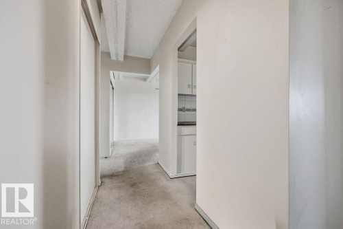 Hallway with textured ceiling and carpet flooring - 1208 9918 101 Street, Edmonton, AB - Indoor Photo Showing Other Room