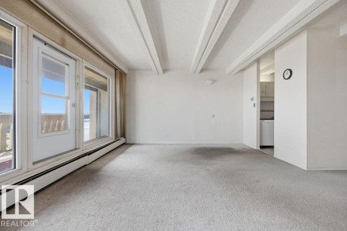 Bright interior space featuring a full-wall glass door and window combination - 1208 9918 101 Street, Edmonton, AB -  Photo Showing Other Room