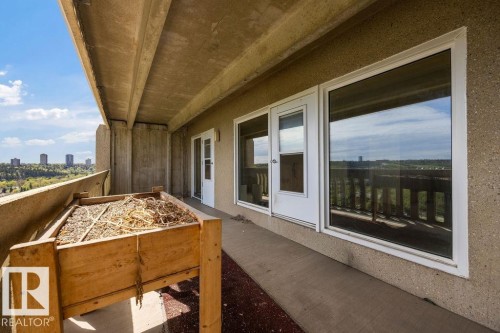 Expansive balcony featuring concrete flooring and a built-in wooden planter - 1208 9918 101 Street, Edmonton, AB - Outdoor With Exterior