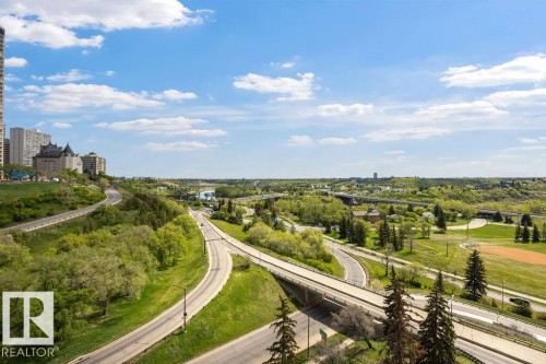 Expansive urban landscape featuring multiple roadways, abundant green spaces, a river, and distant buildings - 1208 9918 101 Street, Edmonton, AB - Outdoor With View