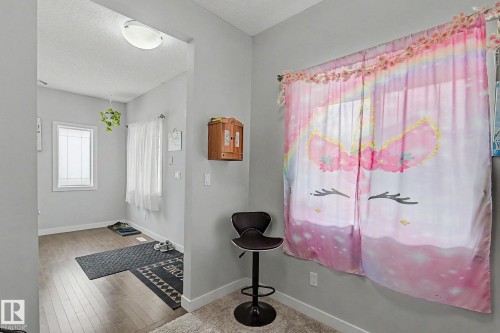 Entryway with wood-finish flooring, light grey painted walls, and white trim - 18144 76 Street, Edmonton, AB - Indoor