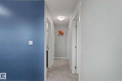 Carpeted hallway with light gray walls and white trim - 18144 76 Street, Edmonton, AB - Indoor Photo Showing Other Room