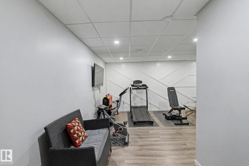 Versatile room featuring wood-finish flooring and recessed lighting - 18144 76 Street, Edmonton, AB - Indoor Photo Showing Other Room