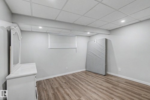 Room featuring wood-finish flooring, recessed lighting, and a drop ceiling - 18144 76 Street, Edmonton, AB - Indoor Photo Showing Other Room
