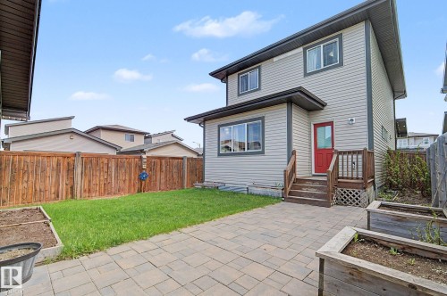 Rear exterior with light gray siding and dark trim - 18144 76 Street, Edmonton, AB - Outdoor