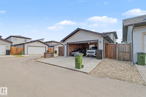 Detached double garage with light-colored siding and dark trim - 18144 76 Street, Edmonton, AB - Outdoor
