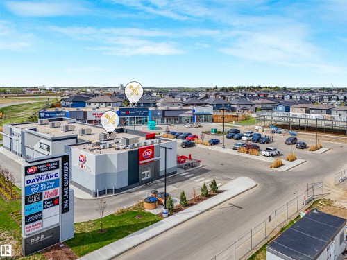 Commercial property featuring multiple retail establishments and a prominent pylon sign - 1518 Siskin Link Link, Edmonton, AB - Outdoor With View