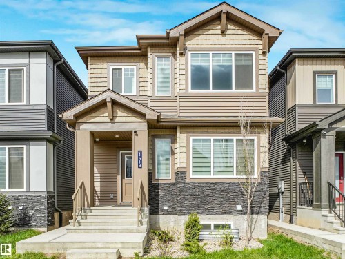 Two-story detached residence featuring horizontal siding, decorative shingles, and a partial stone facade - 1518 Siskin Link Link, Edmonton, AB - Outdoor With Facade